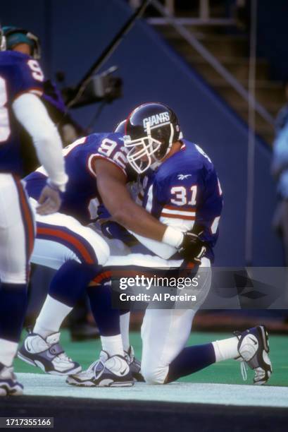 Cornerback Jason Sehorn of the New York Giants has a 23-yard Touchdown off an interception in the game between the New England Patriots vs the New...