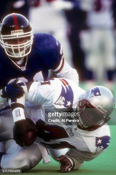Cornerback Jason Sehorn of the New York Giants makes a stop of Tight End Keith Byars of the New England Patriots in the game between the New England...