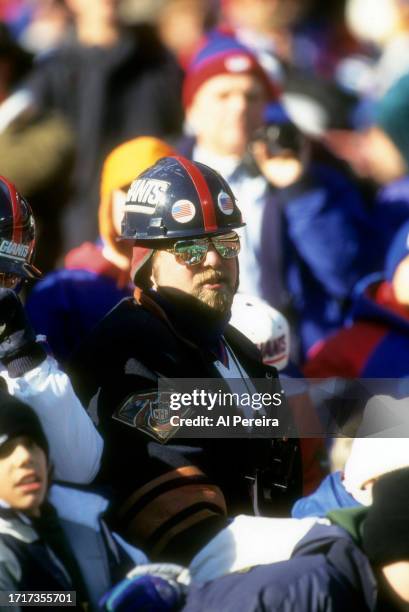 New York Giants Super fan Willie Mariano follows the action in the game between the New England Patriots vs the New York Giants on December 21. 1996...