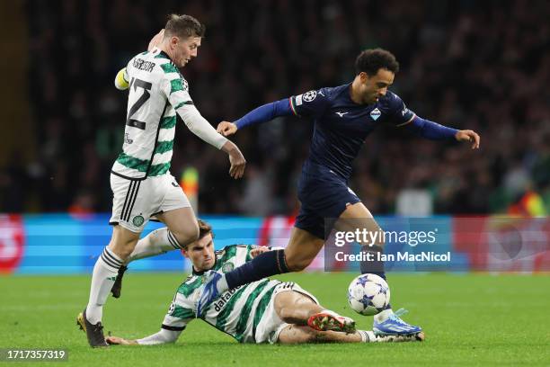 Felipe Anderson of SS Lazio is challenged by Callum McGregor and Matt O'Riley of Celtic during the UEFA Champions League match between Celtic FC and...