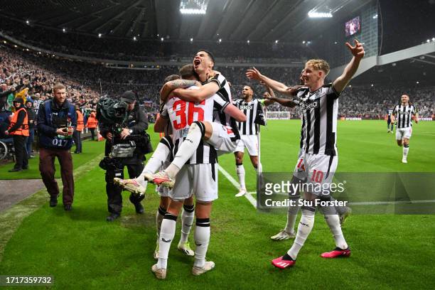 Sean Longstaff of Newcastle United celebrates with Miguel Almiron of Newcastle United after scoring the team's third goal during the UEFA Champions...