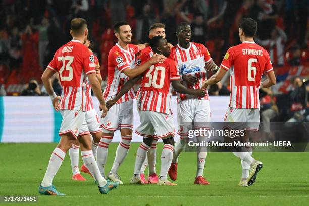 Cherif Ndiaye of FK Crvena zvezda celebrates with teammates after scoring the team's first goal during the UEFA Champions League match between FK...