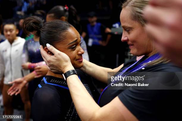 Bronze medalist Melanie de Jesus dos Santos of Team France is embraced by a member of staff from Team United States after the Women's Team Final on...
