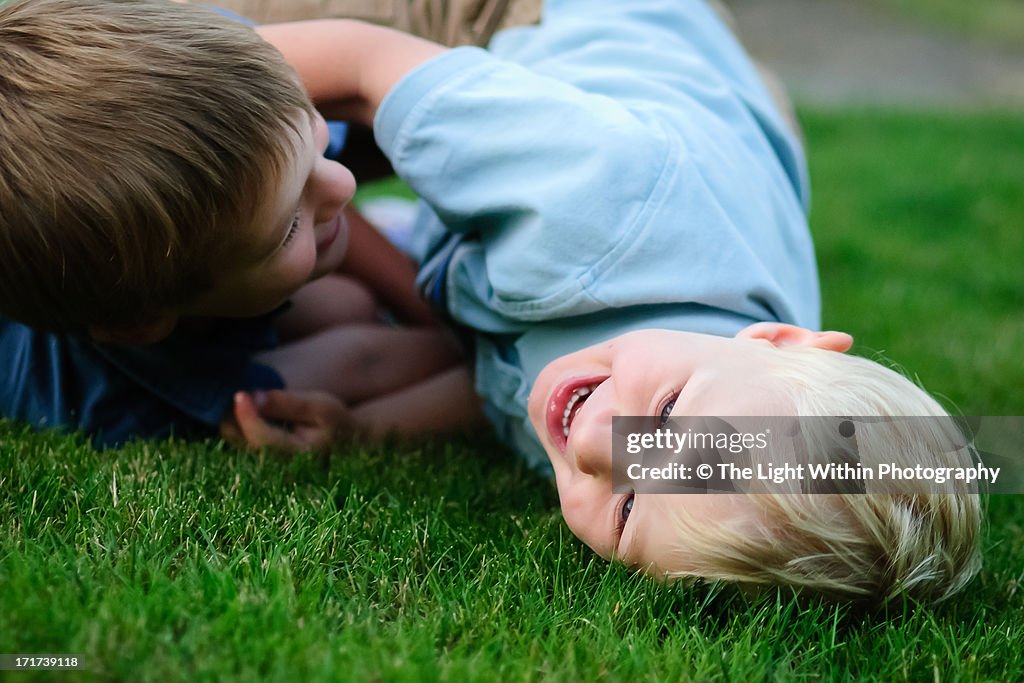 Boys wrestling on the grass