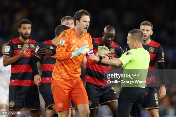 Asmir Begovic of Queens Park Rangers reacts after referee David Webb shows him a red card following the foul on Patrick Bamford of Leeds United...