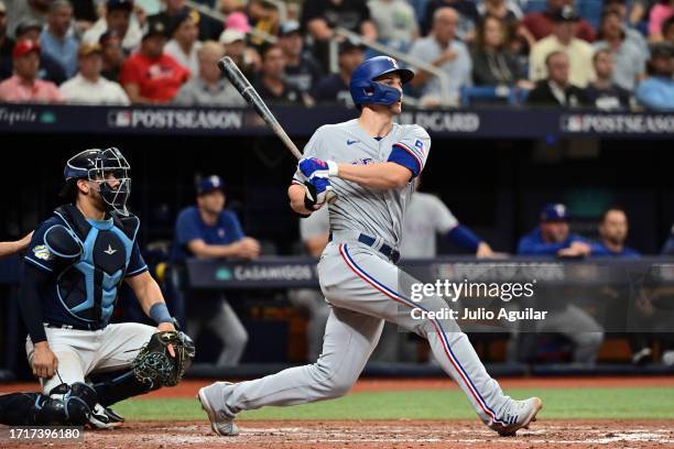 Corey Seager of the Texas Rangers hits an RBI double in the sixth inning against the Tampa Bay Rays during Game Two of the Wild Card Series at...