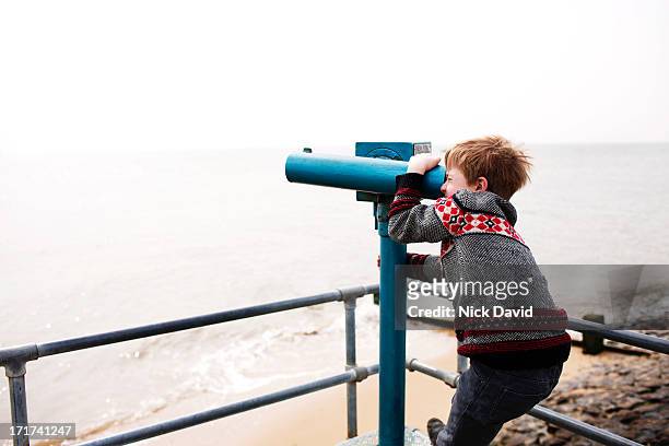 looking through viewpoint binoculars - looking through an object stock pictures, royalty-free photos & images