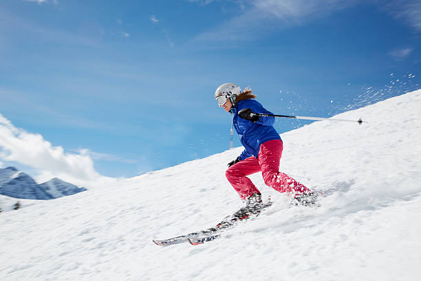 young woman skiing down mountain
