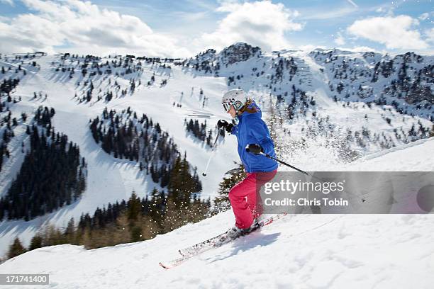 young woman skiing down mountain - zillertal stock pictures, royalty-free photos & images