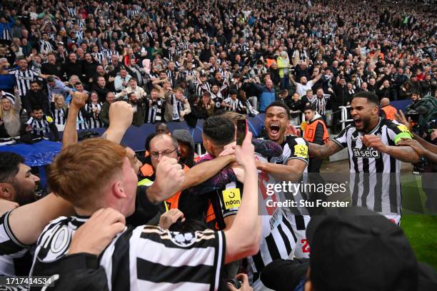 Fabian Schar of Newcastle United celebrates with teammates after scoring the team's fourth goal during the UEFA Champions League match between...