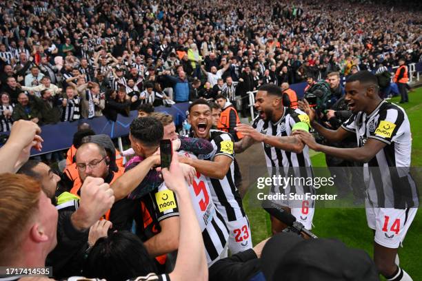 Fabian Schar of Newcastle United celebrates with teammates after scoring the team's fourth goal during the UEFA Champions League match between...