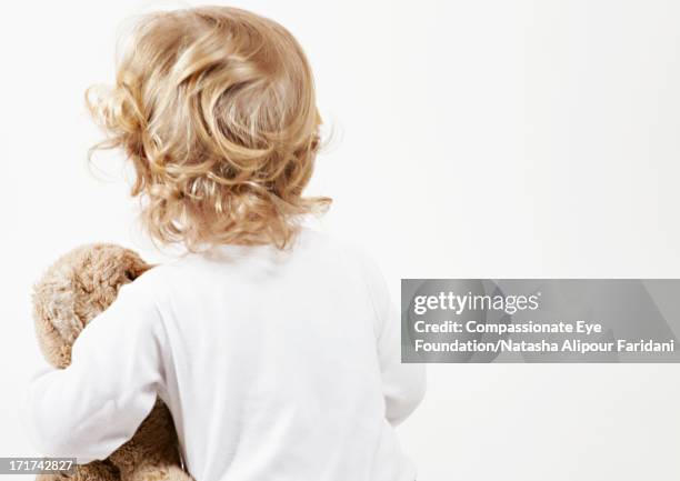 toddler holding teddy bear, rear view - blonde hair rear white background stock pictures, royalty-free photos & images