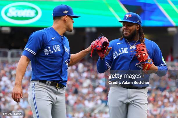 Jose Berrios and Vladimir Guerrero Jr. #27 of the Toronto Blue Jays celebrate an out against the Minnesota Twins during the second inning in Game Two...