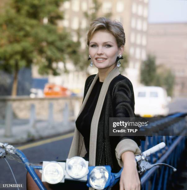 Portrait of British actress Fiona Fullerton as she poses on a multi-seat tandem bicycle, London, England, June 14, 1985.