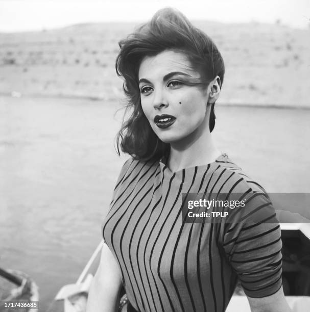 Portrait of American actress Tina Louise as she poses in a motorboat, 1958.