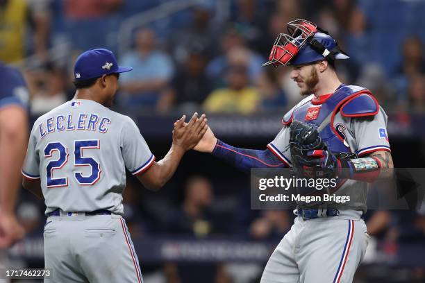 Jose Leclerc and Jonah Heim of the Texas Rangers celebrate after defeating the Tampa Bay Rays 7-1in Game Two of the Wild Card Series at Tropicana...