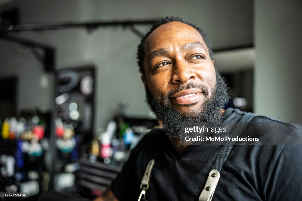 Portrait of proud barbershop owner in his shop