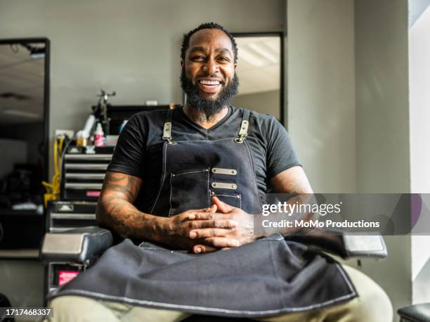 portrait of proud barbershop owner in his shop - african american barber shop stock pictures, royalty-free photos & images