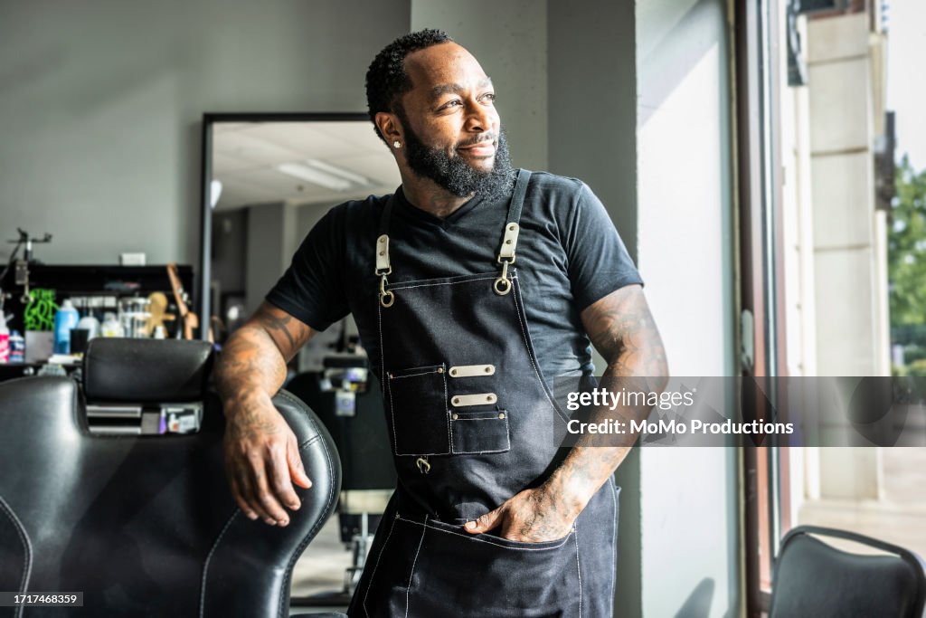 Portrait of proud barbershop owner in his shop