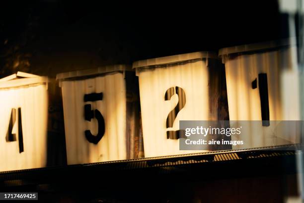 group of containers with numbers in a row on a shelf in a warehouse in side view. - sides 2nd stock pictures, royalty-free photos & images