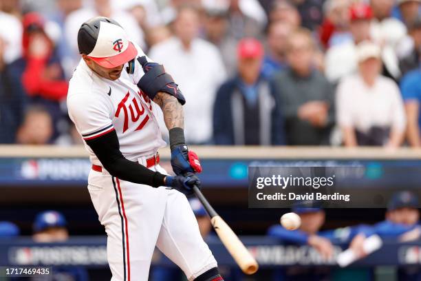 Carlos Correa of the Minnesota Twins hits an RBI single against Yusei Kikuchi of the Toronto Blue Jays during the fourth inning in Game Two of the...