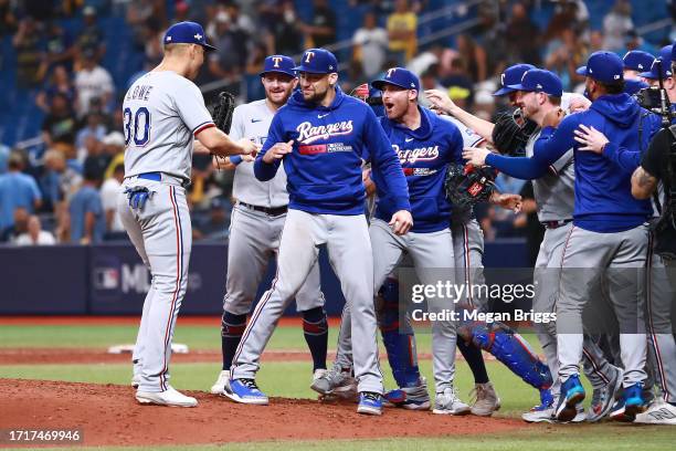 The Texas Rangers celebrate after defeating the Tampa Bay Rays 7-1in Game Two of the Wild Card Series at Tropicana Field on October 04, 2023 in St...