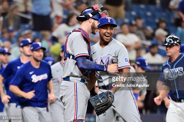 Jose Leclerc and Jonah Heim of the Texas Rangers celebrate after defeating the Tampa Bay Rays 7-1in Game Two of the Wild Card Series at Tropicana...