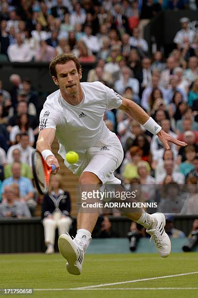 Britain's Andy Murray stetches for the ball to win the point and a game in the first set against Spain's Tommy Robredo during their third round men's...