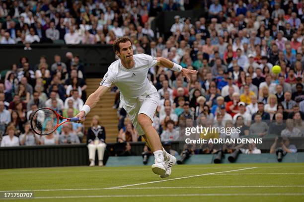 Britain's Andy Murray stetches for the ball to win the point and a game in the first set against Spain's Tommy Robredo during their third round men's...