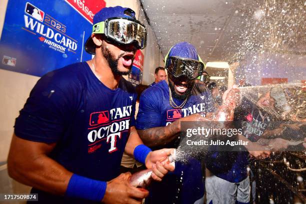 Leody Taveras and Adolis Garcia of the Texas Rangers celebrate in the clubhouse after defeating the Tampa Bay Rays 7-1 in Game Two of the Wild Card...