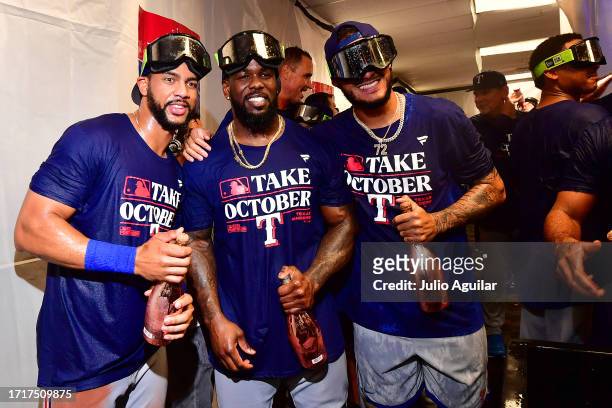 Leody Taveras and Adolis Garcia of the Texas Rangers celebrate in the clubhouse after defeating the Tampa Bay Rays 7-1 in Game Two of the Wild Card...