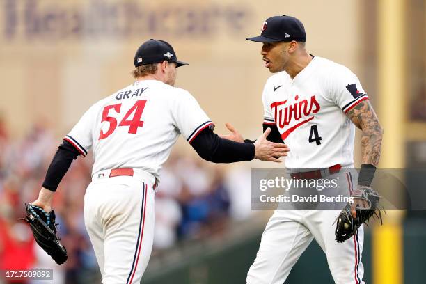 Carlos Correa of the Minnesota Twins celebrates with Sonny Gray after tagging out Vladimir Guerrero Jr. #27 of the Toronto Blue Jays at second base...