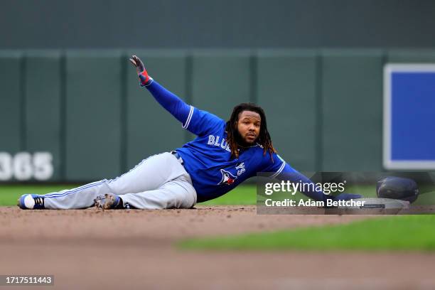 Vladimir Guerrero Jr. #27 of the Toronto Blue Jays reacts after being tagged out at second base against Carlos Correa of the Minnesota Twins during...