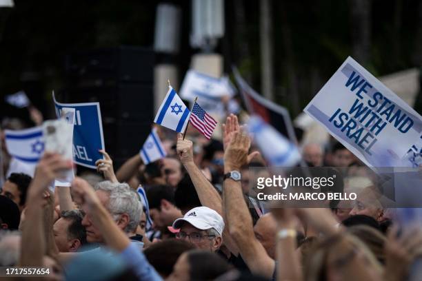 People attend the Israel Solidarity Rally organized by the Greater Miami Jewish Federation at the Holocaust Memorial in Miami Beach, Florida, on...