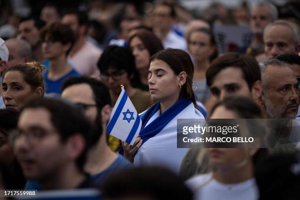People attend the Israel Solidarity Rally organized by the Greater Miami Jewish Federation at the Holocaust Memorial in Miami Beach, Florida, on...