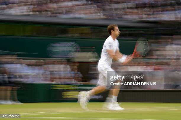 In a picture take with a slow shutter speed Britain's Andy Murray runs for a return against Spain's Tommy Robredo during their third round men's...