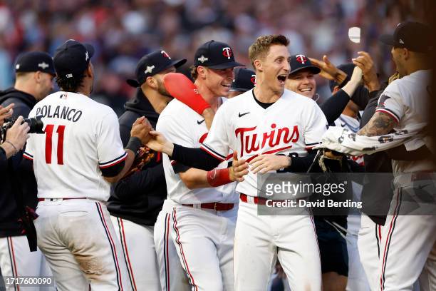 Griffin Jax of the Minnesota Twins celebrates with his teammates after defeating the Toronto Blue Jays in Game Two to win the Wild Card Series at...