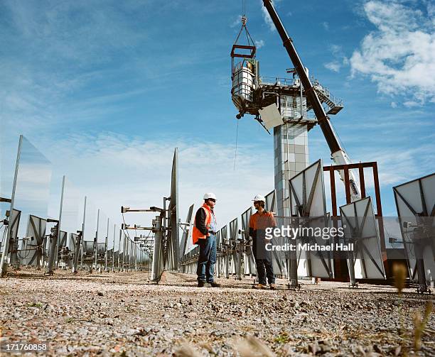 workmen at solar thermal research facility - newcastle new south wales stock pictures, royalty-free photos & images