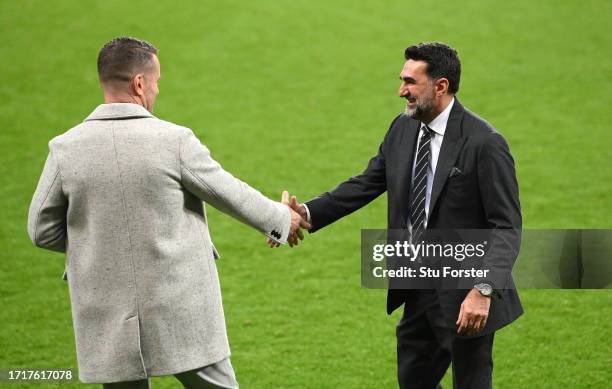 Newcastle chairman Yasir Al-Rumayyan shakes hands with former goalkeeper Shay Given on the pitch after the UEFA Champions League match between...