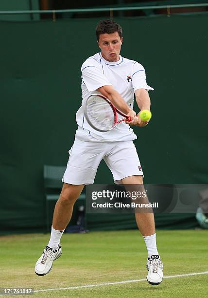 Ken Skupski of Great Britain hits a backhand during the Gentlemens Doubles second round match against Aisam Qureshi of Pakistan and Jean-Julien...