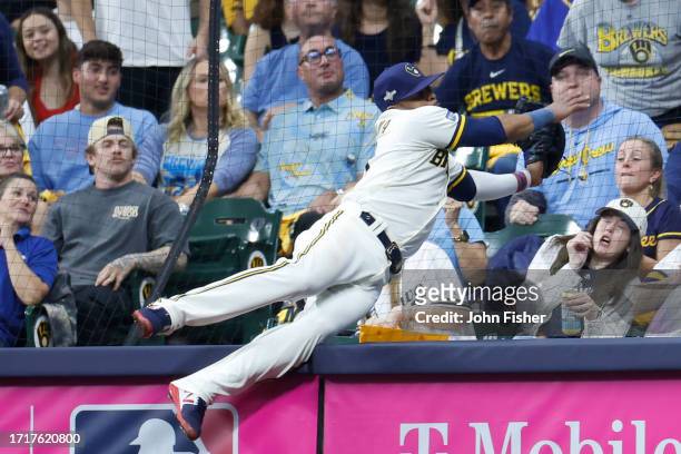 Carlos Santana of the Milwaukee Brewers reaches for a foul ball during the second inning against the Arizona Diamondbacks during Game Two of the Wild...