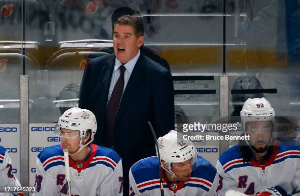 Head coach Peter Laviolette of New York Rangers handles the bench during the game against the New Jersey Devils at Prudential Center on October 04,...