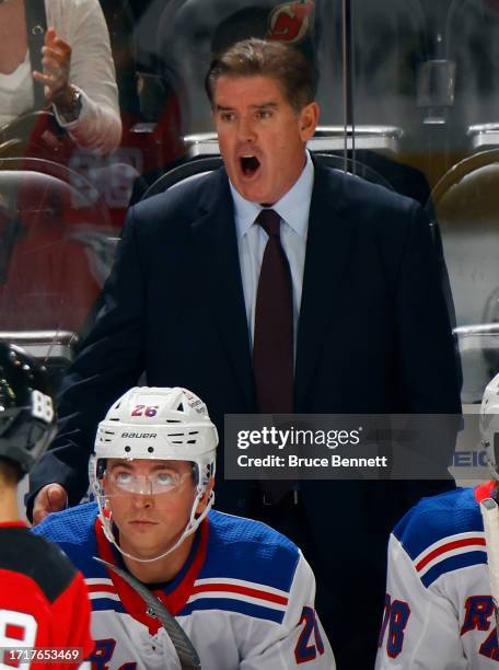 Head coach Peter Laviolette of New York Rangers handles the bench during the game against the New Jersey Devils at Prudential Center on October 04,...