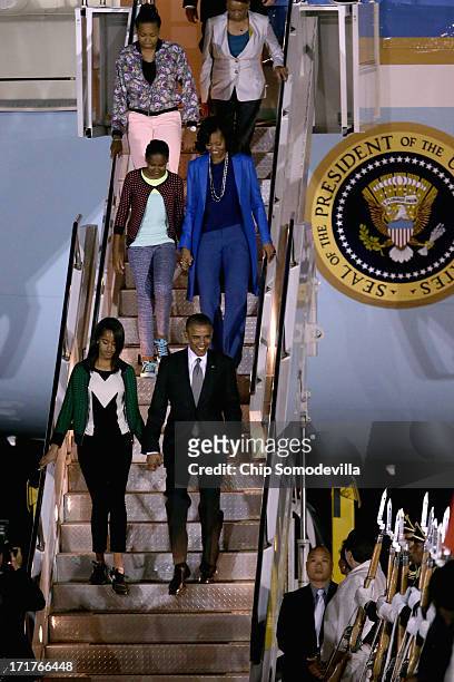 President Barack Obama, first lady Michelle Obama, daughters Sasha Obama and Malia Obama and others arrive at Waterkloof Air Force Base June 28, 2013...