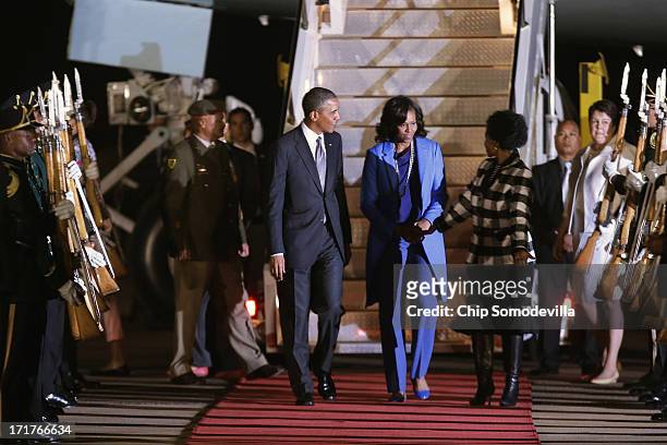 President Barack Obama and first lady Michelle Obama are greeted by Minister of International Relations and Cooperation Maite Mkoana-Mashabne after...