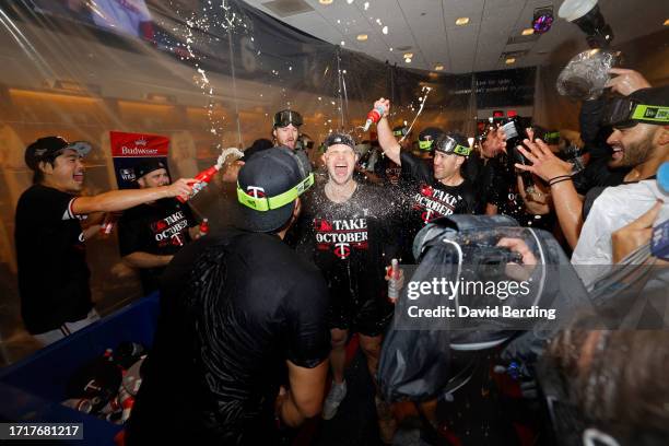 Sonny Gray of the Minnesota Twins celebrates with his teammates in the locker room after defeating the Toronto Blue Jays in Game Two to win the Wild...