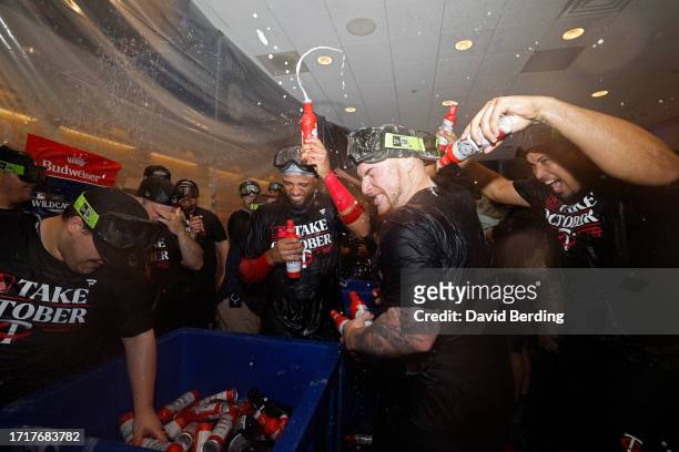 Christian Vazquez and Jhoan Duran of the Minnesota Twins celebrate in the locker room after defeating the Toronto Blue Jays in Game Two to win the...