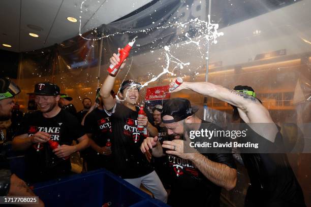 The Minnesota Twins celebrate in the locker room after defeating the Toronto Blue Jays in Game Two to win the Wild Card Series at Target Field on...