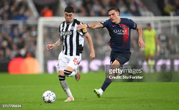 Newcastle player Miguel Almiron races past PSG defender Manuel Ugarte during the UEFA Champions League match between Newcastle United FC and Paris...