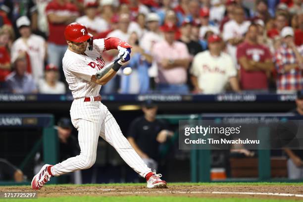 Trea Turner of the Philadelphia Phillies hits a one-run RBI single during the third inning against the Miami Marlins in Game Two of the Wild Card...